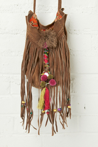 Suede crossbody fringe bag with colorful embroidered detailing, beads, tassels, and pompoms. Braided suede trimming across front